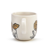 The handle of a cream coffee mug with several simple black and mustard yellow flowers stemming from the base.