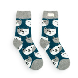 A pair of blue and gray fuzzy socks with cats and a fabric tag that says "check meow-t".