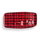 A red and black plaid rectangular serving platter with white drawings of trees and snowflakes.