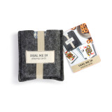 A set of playing cards in a houndstooth pattern with a gray felt card carrier that has elastic around it and a fabric tag that says "Deal Me In playing cards", displayed with packaging.