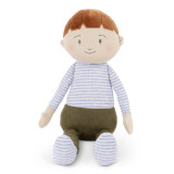 A soft fabric smiling boy doll with brunette hair, dark green pants and a blue striped shirt sitting down facing forward.