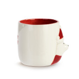 Side view of a cream ceramic handled mug with a raised image of a polar bear in a red scarf and Santa hat. The inside of the mug is red.