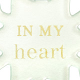 Close up view of the sentiment on a set of two white snowflake shaped ornaments that say "in my heart" and have a metal tag that says "Always".