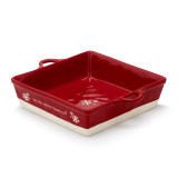 A square red ceramic dish with side handles that says "let the merry times roll" with a white base, displayed angled to the left.