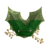 Back view of a green holly shaped fabric lapel pin embellished with red berries and gold stems.