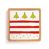 A square ceramic trivet with red lines and Christmas trees at the top sitting in a cork base.