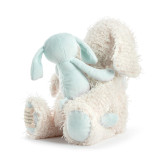 A fuzzy plush cream elephant holding a light blue baby plush elephant, displayed angled away to the left.