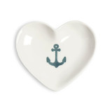 A white ceramic heart shaped trinket dish with an image of an anchor in the middle.