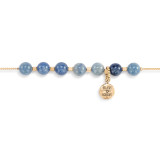 Detail view of the beads and charm on an adjustable gold chain bracelet with 7 blue and gold beads. There is a round gold charm that says "Believe Achieve" that can move between the seven beads.