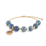 An adjustable gold chain bracelet with 7 blue and gold beads. There is a round gold charm that says "Believe Achieve" that can move between the seven beads, displayed at a low angle to show detail.