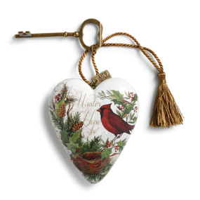 White heart pendant with green branches. red bird, and gold key attatched with gold tassle