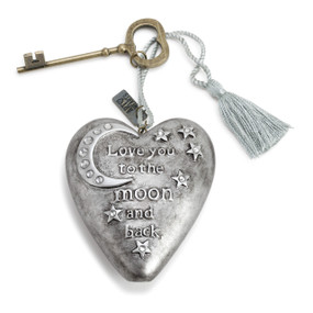 Gray metallic heart with a moon, stars, and raised lettering. Tassel and bronze key attached to heart.