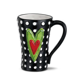 Black coffee mug with white polka dots and green heart with red heart inside centered