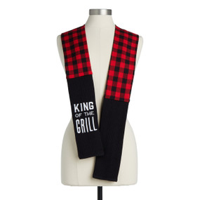 A red and black check fabric kitchen boa with black towel ends and embroidery that says "King of the Grill" displayed on a mannequin.