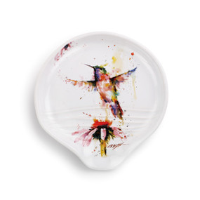 Round white dish with rainbow hummingbird print above flower
