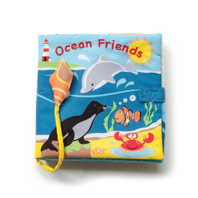 Small blue ocean cloth book with 'ocean friends' printed on above whales and fish and crabs