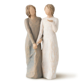 Front view of two standing female figures, one in cream dress, one in blue-gray dress, holding hands and turned as if speaking to each other