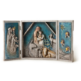 Heavy cream box with hinged doors open to show bas-relief carving of Nativity scene in blue and gold leaf
