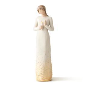 Front view of standing female figure in cream dress with gold dots at bottom, holding candle with gold-leaf flame