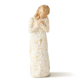 Front view of standing female figure in cream dress carved with gold organic designs, holding hands crossed at chest