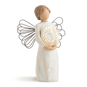 Front view of standing figure with short light hair in cream dress with wire wings, holding gold pierced-metal wreath of hearts
