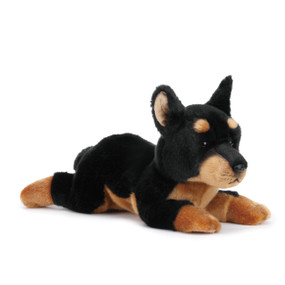 Stuffed black/brown dog animal laying down - ears are sticking up