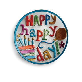 Round dish with 'happy happy day!' in rainbow letters next to rainbow cake