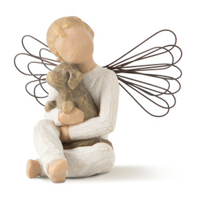Front view of seated child figure with wire wings in cream top and pants, holding brown dog in lap