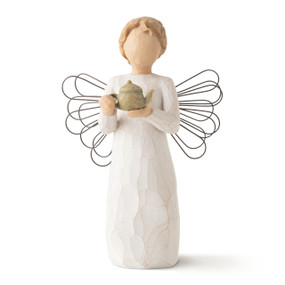 Front view of standing female figure with cream dress and wire wings, holding a green teapot in hands