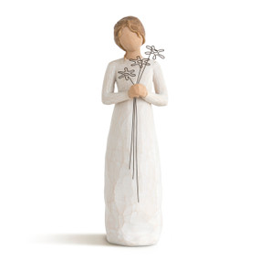 Front view of standing female figure in cream dress, holding wire flowers with long stems