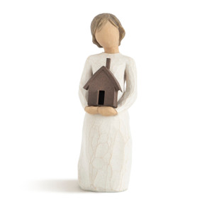 Front view of standing female figure with rusted metal house in arms