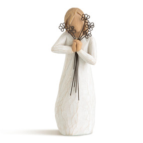 Front view of standing female figure in cream dress, holding wire flowers with long stems around face