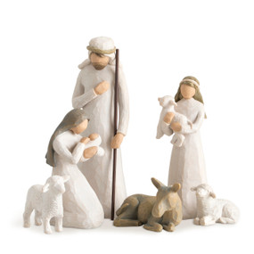 Front view of six figures: male in cream robes holding staff, kneeling female in cream dress holding baby, boy in cream robes carrying lamb, gray donkey, two white sheep