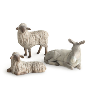 Front view of set of three animals: gray donkey lying down with cream blanket on back, and two cream sheep, one standing, one laying down