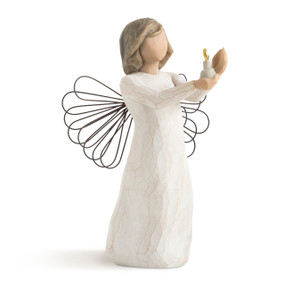 Front view of standing figure in cream dress with wire wings, holding out a small gold-flamed candle in hands