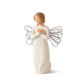 Front view of standing female figure with wire wings in cream dress carved with natural symbols, hands crossed under gold heart on chest