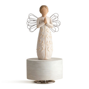 Femal angel figure in cream dress carved with a tree design and wire wings, holding hands in prayer position, standing atop round, cream wood base