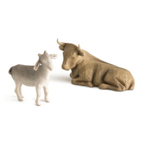 Front view of standing up gray goat and lying down brown ox