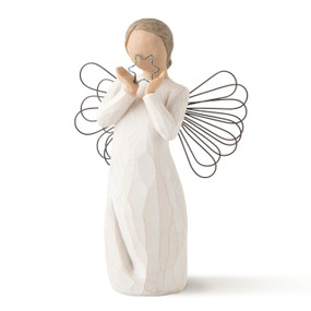 Front view of standing female figure with wire wings in cream dress, holding silver wire star in hands
