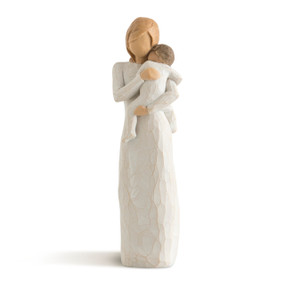 Front view of standing female figure in cream dress holding toddler in cream onesie