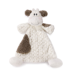 A brown and cream blankie with the smiling face of a cow.