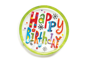 A round glass plate with "Happy Birthday" in a variety of bright colors and patterns in the center.