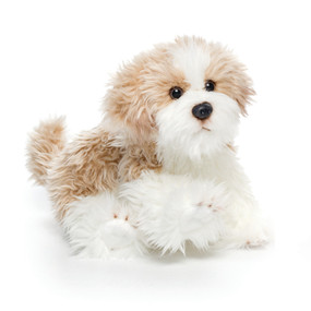 Small stuffed brown and white shaggy sitting dog