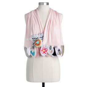 A light pink fabric activity scarf with baby sensory activities at the ends all in a floral and nature theme, displayed on a mannequin.