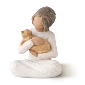 Front view of seated figure with dark hair, holding orange cat in arms