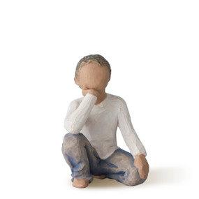 Front view of half-kneeling figure wearing cream shirt and blue jeans, with hand under chin