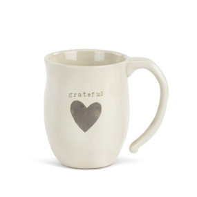 Side view of white mug that says 'grateful' on it in grey above grey heart