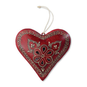 Small red heart figurine with gold designs and white string