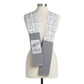 A black and white kitchen themed fabric kitchen boa with gray towel ends and a white fabric patch that says "Cooks Well with Others" displayed on a mannequin.