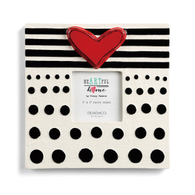 Close front view of white frame with black polka dots and stripes on it